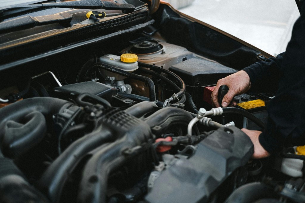 Mechanic fixing a car to signify how important proper servicing for a diesel car is.