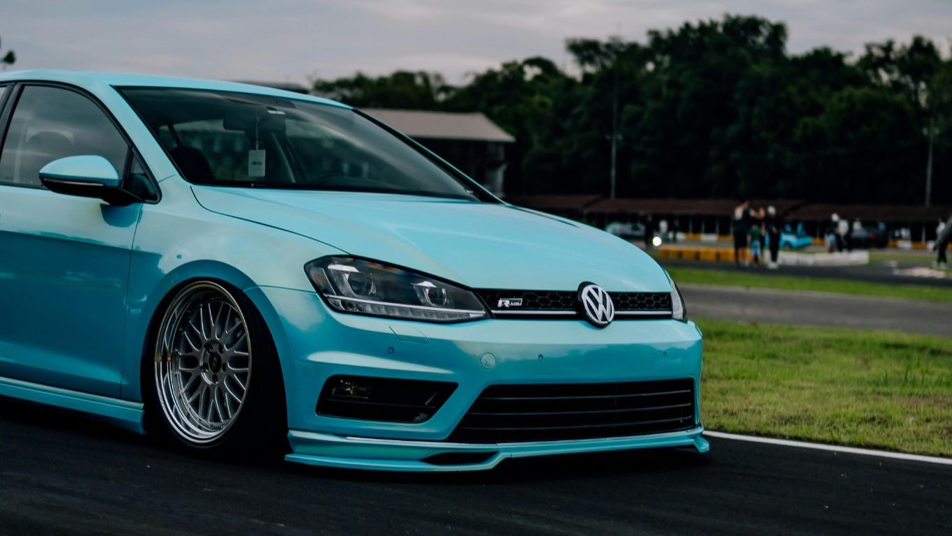 sky blue VW Golf on a track
