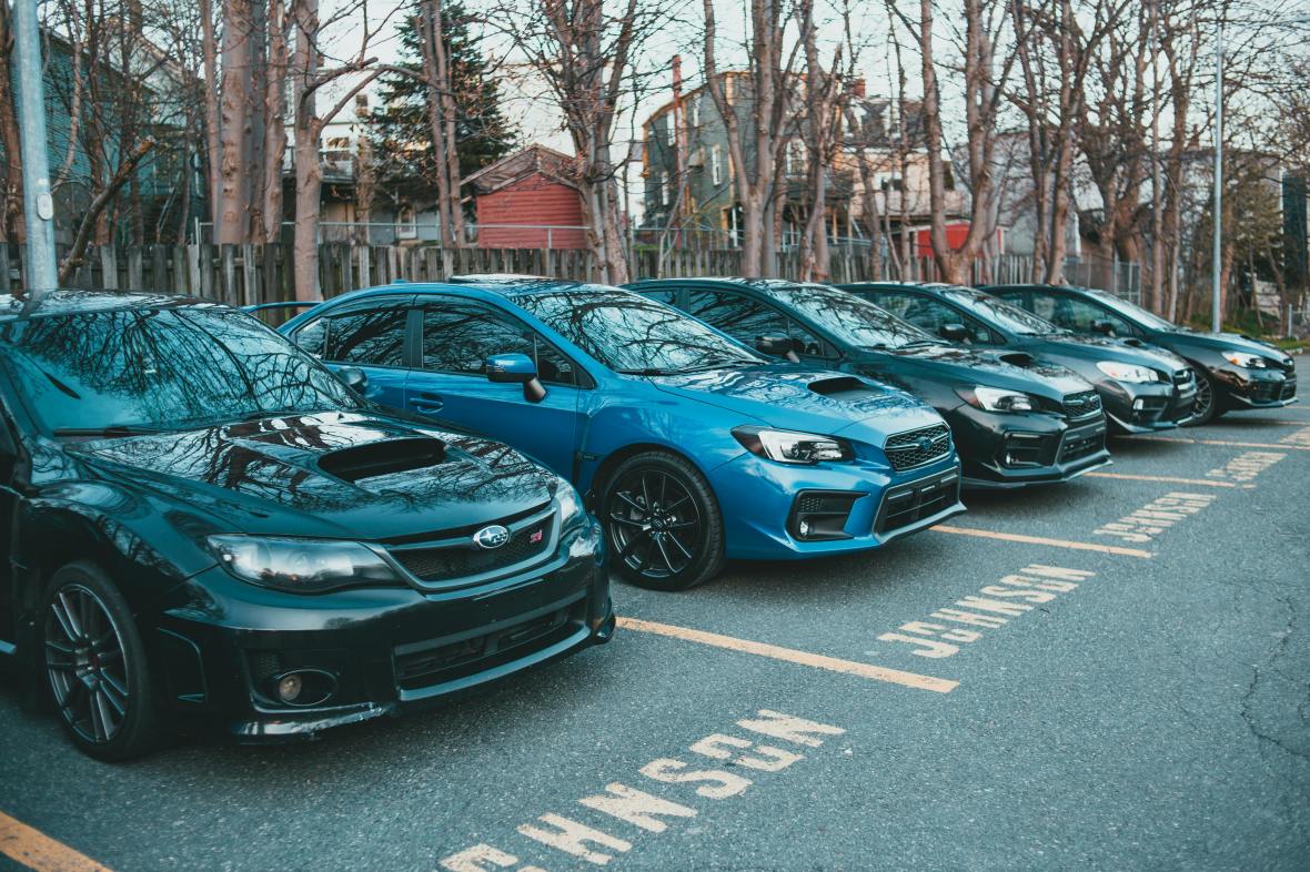 Small diesel cars from different brands like Subaru and Mercedes in a parking lot